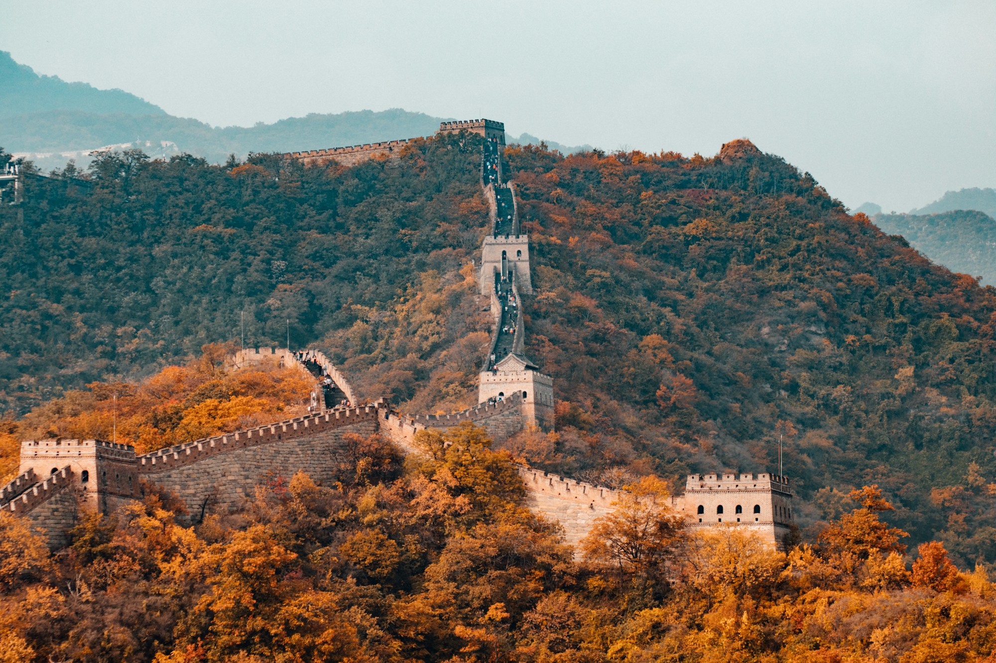 The Great Wall winding across forested mountains in China